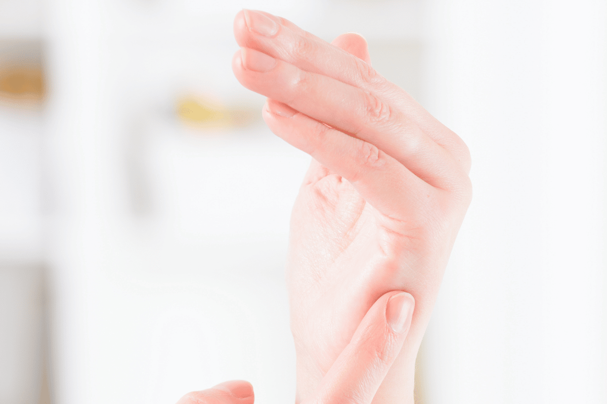 Fingers tapping on the side of the hand, one of the EFT Tapping Points used for stress relief.