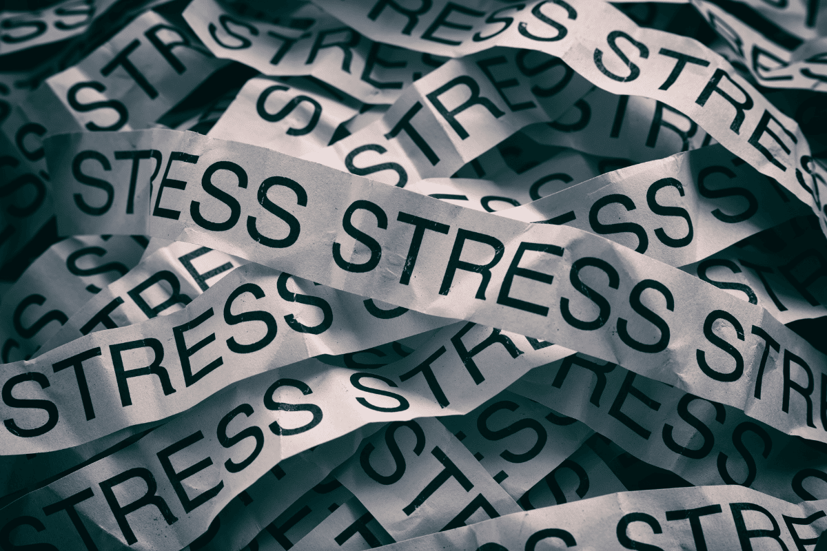 Stress written many times on strips of paper piled up.
