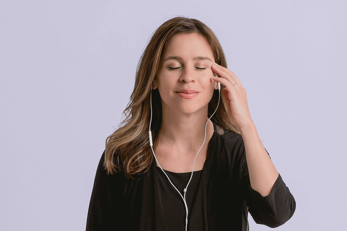 Jessica Ortner wearing headphones doing a guided EFT Tapping meditation